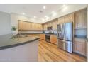 Well-lit kitchen with stainless steel appliances, wood cabinets, and hardwood floors at 20750 N 87Th St # 2062, Scottsdale, AZ 85255