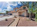 Inviting two-story home featuring a covered entry, two-car garage, and well-kept yard at 22074 W Papago St, Buckeye, AZ 85326