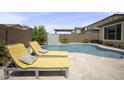 Resort-style backyard with a beautiful private pool and comfortable lounge chairs at 23018 E Mewes Rd, Queen Creek, AZ 85142