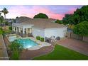 Backyard view with a swimming pool, spa, tile roof, an outdoor lounge area and professional landscaping at 2625 N 24Th St # 22, Mesa, AZ 85213
