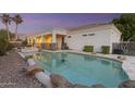Sparkling pool and spa with rock features, enclosed by a safety fence, offering a private backyard retreat at 2625 N 24Th St # 22, Mesa, AZ 85213