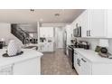 Bright, modern kitchen with white cabinets, stainless steel appliances, and an island at 2648 E Teakwood Pl, Chandler, AZ 85249