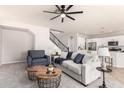 Comfortable living room featuring neutral tones, a ceiling fan, and an open floor plan at 2648 E Teakwood Pl, Chandler, AZ 85249