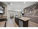 Kitchen with granite countertops, stainless steel appliances and an island including a sink and dishwasher at 30963 W Columbus Ave, Buckeye, AZ 85396