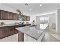 Kitchen featuring granite countertops, stainless steel appliances and breakfast area at 36085 W Prado St, Maricopa, AZ 85138