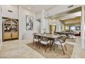 Bright dining room featuring tile floors, light wood table and seating with built in hutch at 39032 N 101St Way, Scottsdale, AZ 85262