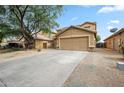Charming single-Gathering home featuring a well-maintained yard, desert landscape, and a two-car garage at 4587 E Silverbell Rd, San Tan Valley, AZ 85143
