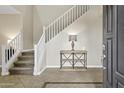 Elegant entryway with a staircase and decorative console table with lamp at 4647 E County Down Dr, Chandler, AZ 85249