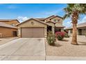 Charming two-story home with desert landscaping and a palm tree in the front yard at 5220 W Desert Ln, Laveen, AZ 85339
