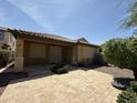 Relaxing back patio with a tiled surface, covered area, and easy access to lush backyard landscaping at 5420 S Mariposa Dr, Gilbert, AZ 85298