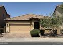 Charming single-story home featuring a two-car garage and manicured front yard at 5420 S Mariposa Dr, Gilbert, AZ 85298