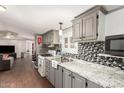 Well-lit kitchen featuring granite countertops, mosaic backsplash, and modern appliances at 5601 W Missouri Ave # 254, Glendale, AZ 85301