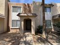 Close up of the front exterior of the townhome featuring a covered entryway and shade trees at 7126 N 19Th Ave # 108, Phoenix, AZ 85021