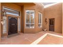 Enclosed patio featuring tile flooring, decorative windows, and an ornate metal door at 8255 E Yearling Rd, Scottsdale, AZ 85255
