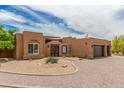 Beautifully landscaped Southwestern home with desert landscaping and brick driveway at 8255 E Yearling Rd, Scottsdale, AZ 85255
