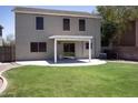 Spacious backyard featuring green grass, a covered patio, and privacy fencing at 8514 S 49Th Dr, Laveen, AZ 85339