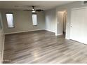Expansive living area showcases modern floors, ample windows, and a sleek ceiling fan at 8514 S 49Th Dr, Laveen, AZ 85339
