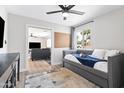 Cozy bedroom with a daybed, ceiling fan, and view into living room at 8714 E Plaza Ave, Scottsdale, AZ 85250