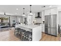 Bright kitchen with an island featuring barstool seating and stainless steel appliances at 8714 E Plaza Ave, Scottsdale, AZ 85250