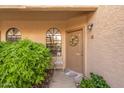 Inviting front door with a decorative wreath and desert landscaping, welcoming guests to this charming home at 930 N Mesa Dr # 1045, Mesa, AZ 85201