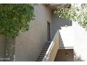 Exterior of the building showing stairs leading to upper-level units at 9600 N 96Th St # 267, Scottsdale, AZ 85259