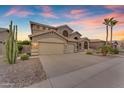 Beautiful two-story house with a three-car garage and mature desert landscaping at 9702 E Naranja Ave, Mesa, AZ 85209