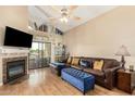 Cozy living room with fireplace, comfortable seating, and seamless access to the outdoors at 10301 N 70Th St # 223, Paradise Valley, AZ 85253