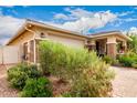 Charming single-story home featuring a two-car garage and welcoming front porch with mature landscaping at 10545 E Texas Ave, Mesa, AZ 85212