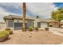 Attractive single-story home featuring desert landscaping and a two-car garage at 10760 W Encanto Blvd, Avondale, AZ 85392