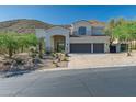 Beautiful two-story home featuring desert landscaping and mountain views at 11446 E Sweetwater Ave, Scottsdale, AZ 85259
