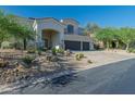 Charming desert home featuring an arched entrance and three car garage at 11446 E Sweetwater Ave, Scottsdale, AZ 85259