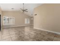 Bright living room showcasing tile flooring, plantation shutters, and recessed lighting at 13015 W Blue Sky Dr, Sun City West, AZ 85375