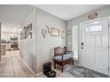 Warm entryway with a decorative bench, tiled floors, and neutral walls adorned with tasteful decor at 14417 N 151St Dr, Surprise, AZ 85379