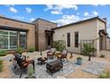 A cozy outdoor patio area with a fire pit, lounge chairs, and desert landscaping at 14551 N Adero Canyon Dr, Fountain Hills, AZ 85268