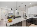 Bright kitchen with white countertops, dark cabinetry, and adjacent living room seating at 1642 E Monte Vista Rd # 5, Phoenix, AZ 85006