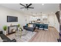 Open-concept living room with modern decor, adjacent kitchen, and staircase at 1642 E Monte Vista Rd # 5, Phoenix, AZ 85006