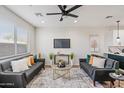 Cozy living room featuring twin sofas, modern decor, and a view into the kitchen at 1642 E Monte Vista Rd # 5, Phoenix, AZ 85006