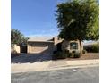 Charming single-story home featuring a desert landscape, covered front porch, and a two-car garage at 18575 W Vogel Ave, Goodyear, AZ 85338