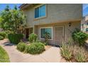 Charming condo entrance with lush landscaping and well-maintained walkway at 19601 N 7Th N St # 1072, Phoenix, AZ 85024