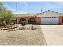 Single-Gathering home showcasing a charming exterior, stucco walls, arched features, desert landscaping, and a two-car garage at 2027 N 81St St, Scottsdale, AZ 85257