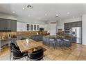Bright kitchen features two-tone cabinets, an island with bar seating, and stainless steel appliances at 2105 E San Carlos Pl, Chandler, AZ 85249