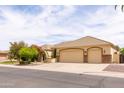 Well-maintained home showcasing a three-car garage, desert landscaping, and inviting curb appeal at 2203 E Tonto Pl, Chandler, AZ 85249