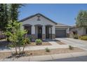 Inviting single-Gathering home with a two-car garage and well-maintained front yard landscaping at 22463 E Desert Spoon Dr, Queen Creek, AZ 85142