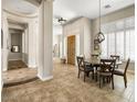 Open-concept dining area featuring tile floors, natural light, and seamless flow to other rooms at 26409 N 49Th Ln, Phoenix, AZ 85083