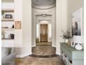 Elegant foyer showcasing tile floors, decorative columns, and a view of the front door at 26409 N 49Th Ln, Phoenix, AZ 85083