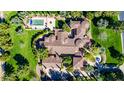 Aerial shot showing a beautiful terracotta tile roof, pristine yard, and a private swimming pool at 29 E Oakwood Hills Dr, Chandler, AZ 85248