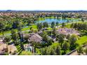 Stunning aerial view of an estate home with pool, lush landscaping, and lake views at 29 E Oakwood Hills Dr, Chandler, AZ 85248