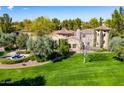 Attractive home featuring a well-manicured lawn, circular driveway, and a decorative fountain at 29 E Oakwood Hills Dr, Chandler, AZ 85248