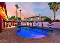 Beautiful swimming pool with palm trees and pink sky at dusk at 3037 E Mallory St, Mesa, AZ 85213