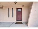 Close up of the front door with decorative glass and sidelight windows at 3124 W Port Royale Ln, Phoenix, AZ 85053
